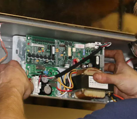 a man is working on an electronic board