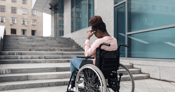 a student on a wheelchair in front of the school